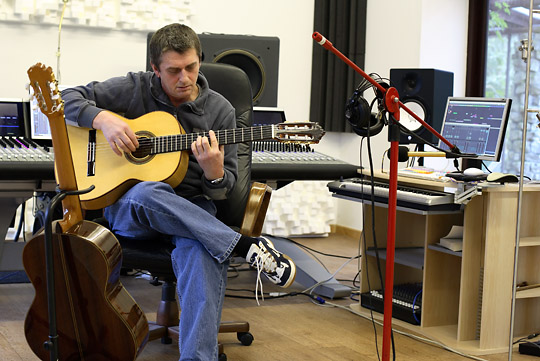 mike oldfield in his studio playing guitar