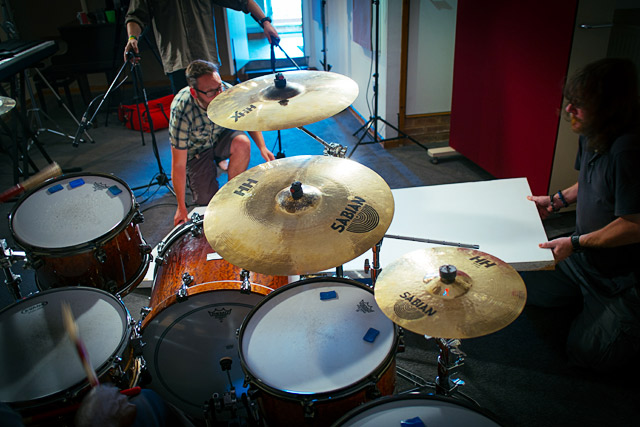 Austen Kilburn and Mike Exeter place a door in front of the drum kit