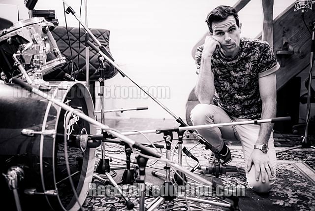 Clint Murphy sitting by drums he is recording