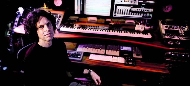 George Shilling in his studio reviewing recording equipment